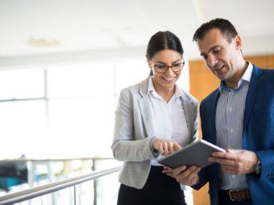 Women and man discussing strategy with a tablet