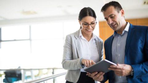 Women and man discussing strategy with a tablet