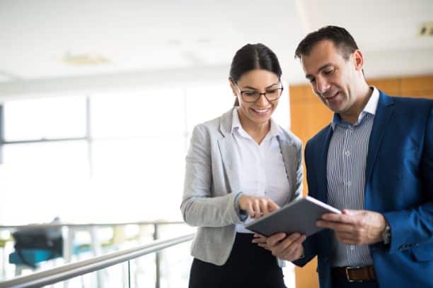 Women and man discussing strategy with a tablet