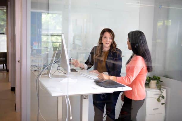 Two women discussing work