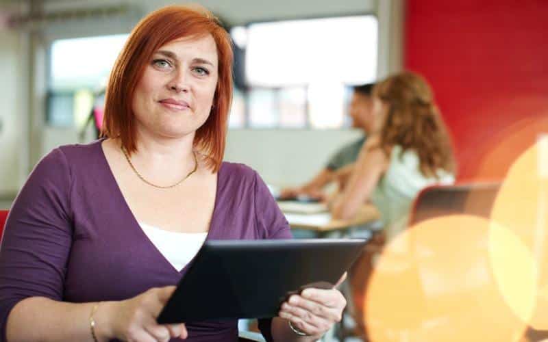 Lady at work holding an ipad