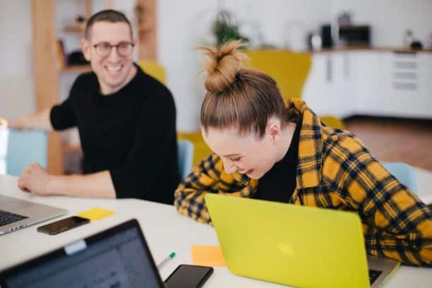 A woman laughing with a team member