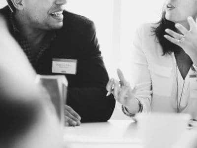 Two people talking at a desk