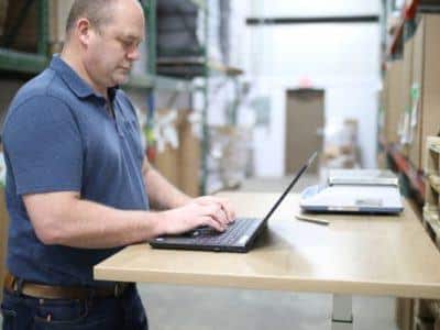 Man working at a desk in a warehouse