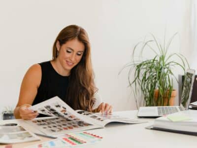 Creative graphic designer sitting at desk with graphic design portfolio ideas