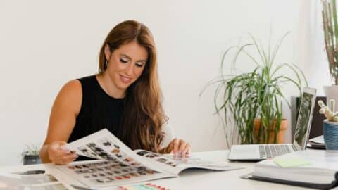 Creative graphic designer sitting at desk with graphic design portfolio ideas