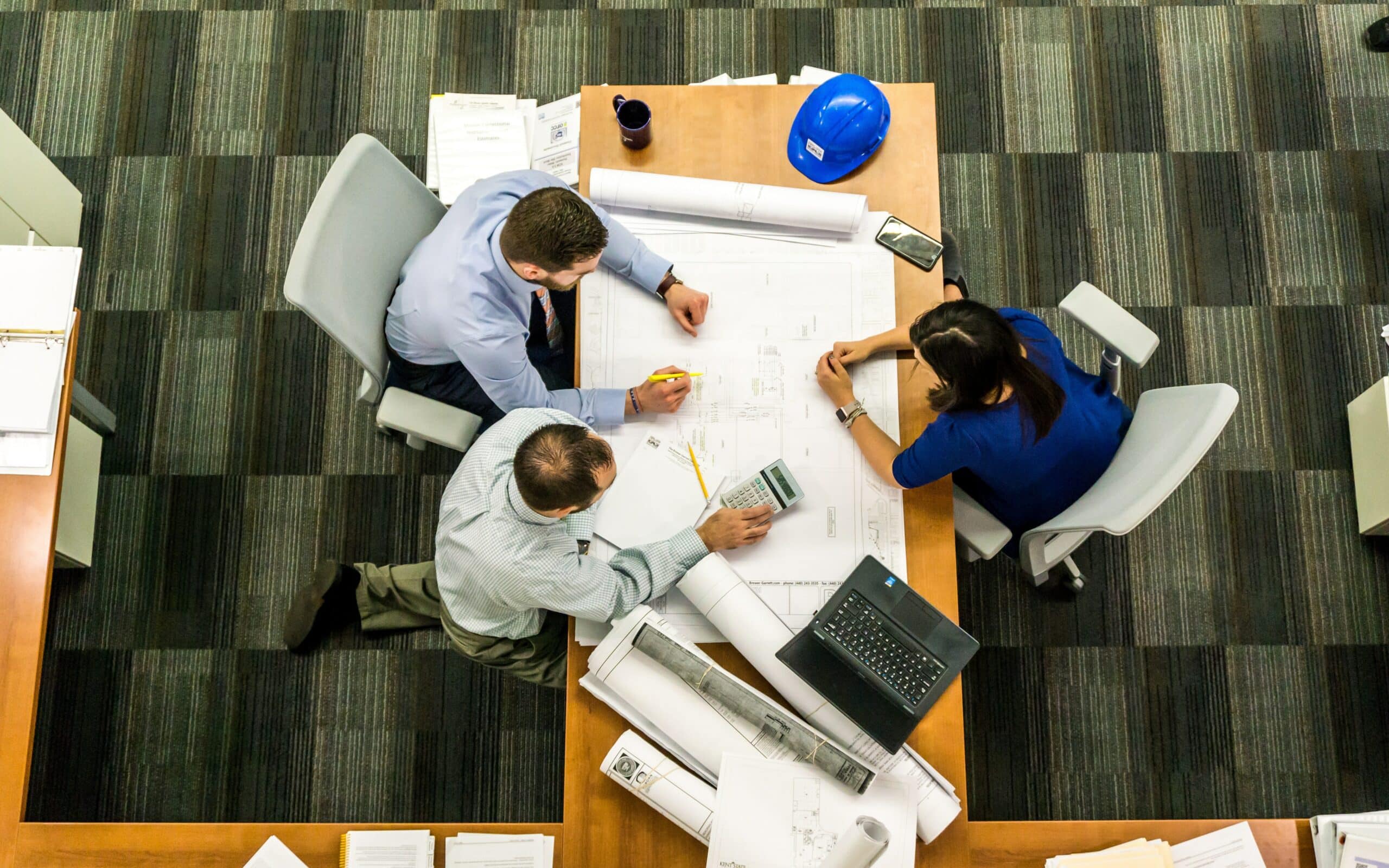 Birds eye view of project manager working with engineers